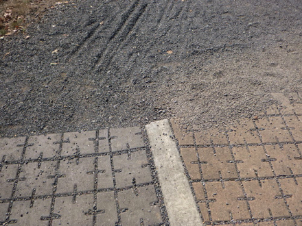 Concrete pavers from the main parking lot and Wildlife Center transition to the gravel trail to bus stop Concrete pavers from the main parking lot and Wildlife Center transition to the gravel trail to bus stop